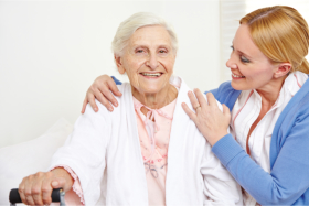 Happy senior accompanied by a caregiver