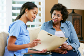 Caregiver showing a document to a senior