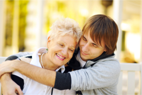 Caregiver hugging a senior