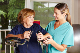 Caregiver assisting a senior in walking